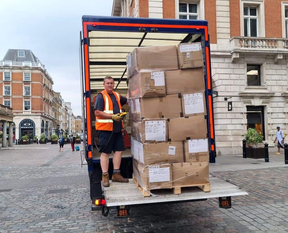 IFL driver inside van standing next to a palletised freight