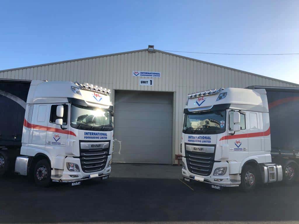 Two IFL trucks outside a warehouse entrance 