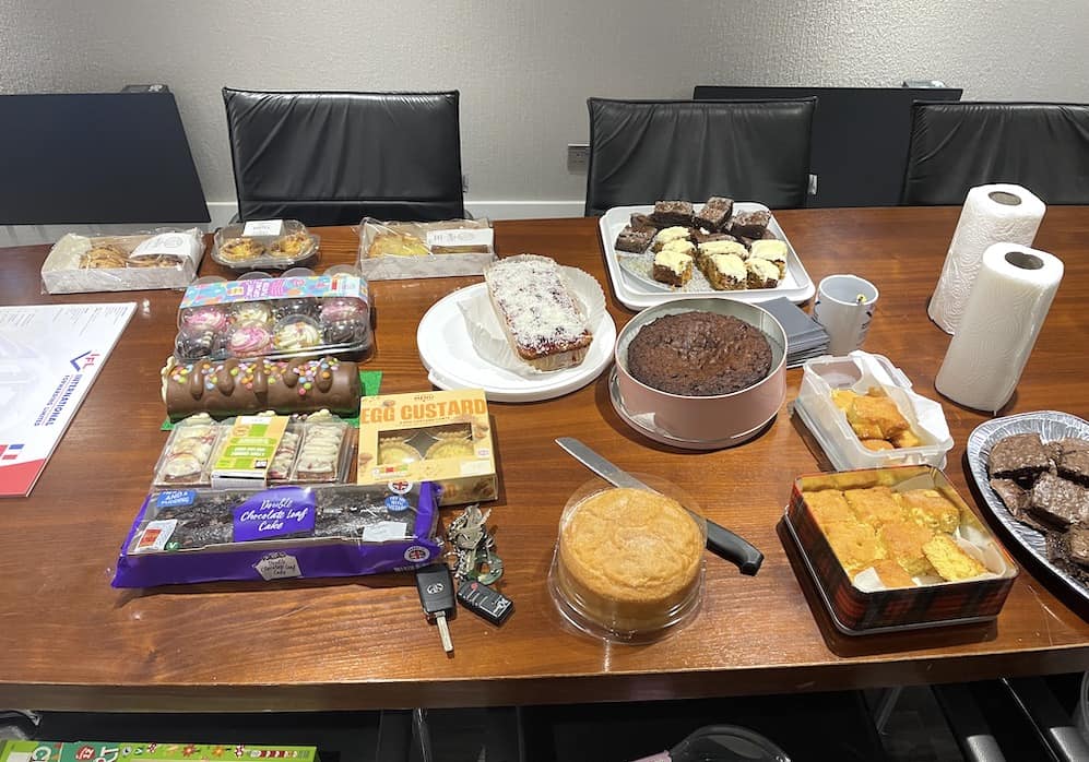 boardroom table full of cakes