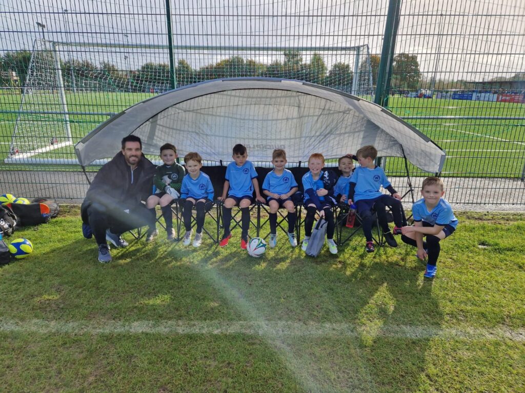Andy Grubb with some of the Studley U-7s players on the subs bench